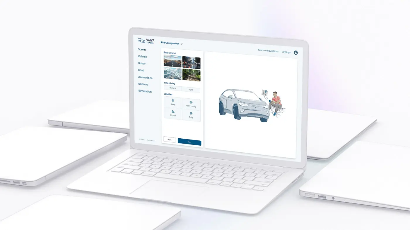 A white laptop surrounded by folded closed laptops displaying the VAIVA simulator RGB Configuration interface, showing a scene editor with environment, vehicle, and weather settings alongside a 3D illustration of a car and a person.